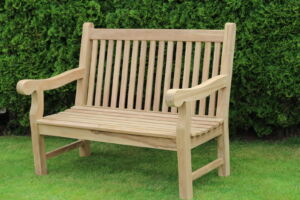 Wooden slatted garden bench with armrests on a lawn - Greenhouse Staging